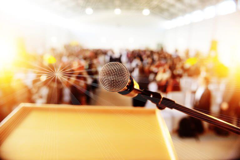 Podium with microphone infront of people seated